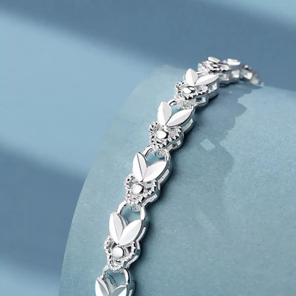 Close-up of a 925 Sterling Silver chain bracelet by Evie's Dreamland featuring intricate floral links.