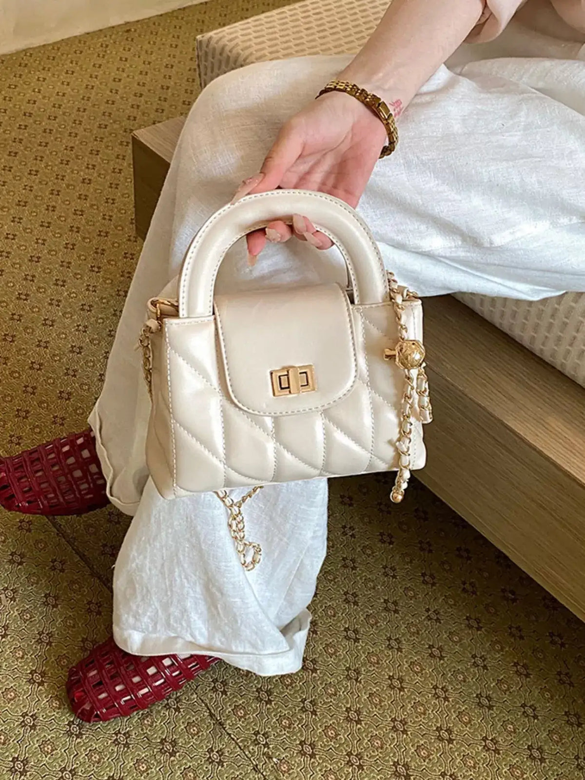 Small cream quilted PU leather crossbody bag with gold chain strap and handle from Evie's Dreamland.