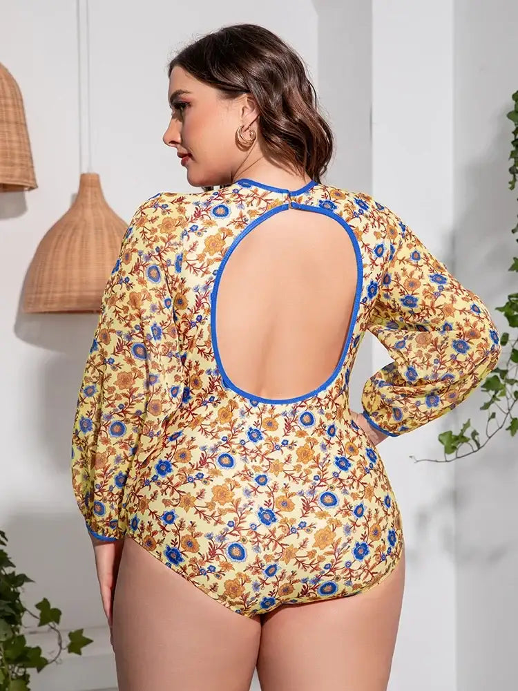Back view of the open back floral one-piece swimsuit showing the flirty low-back design.