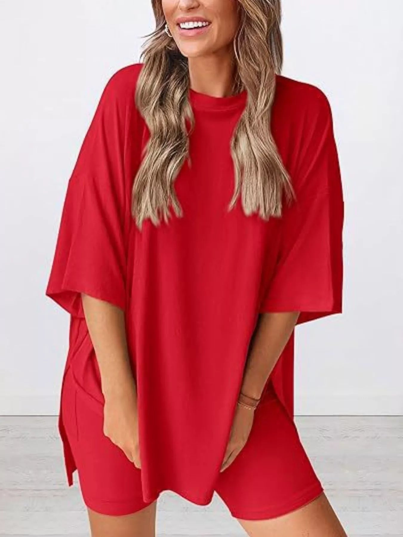 Woman wearing oversized red t-shirt and red biker shorts set, casual lounge outfit