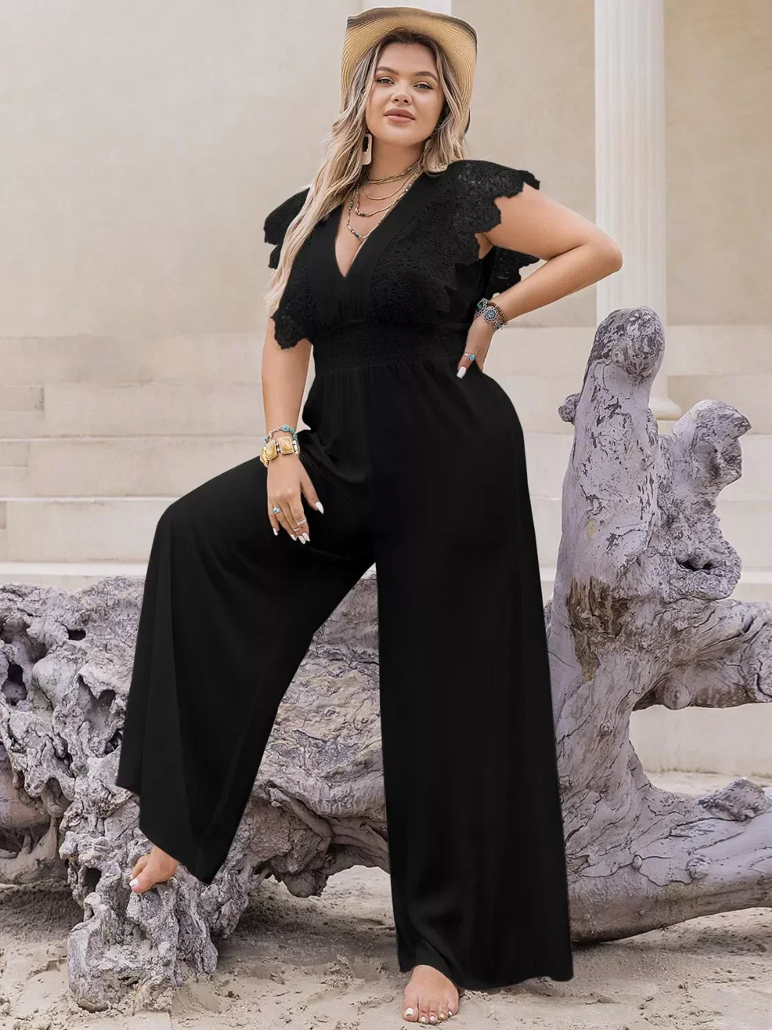 Plus size lace cap sleeve wide leg jumpsuit showcasing elegant curvy style in breathable viscose fabric