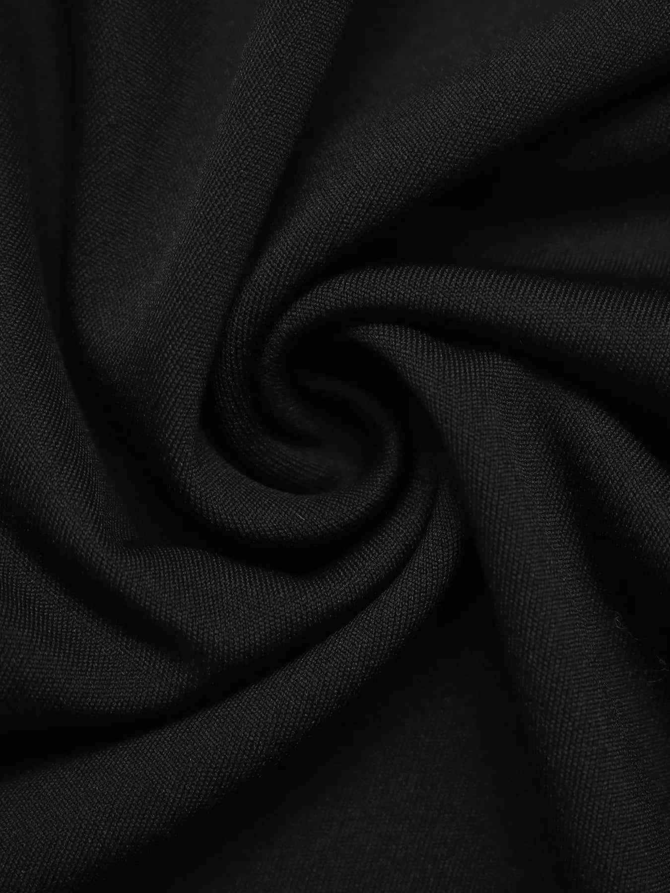 Close-up of black fabric swirl showcasing soft, textured woven material with fine detail