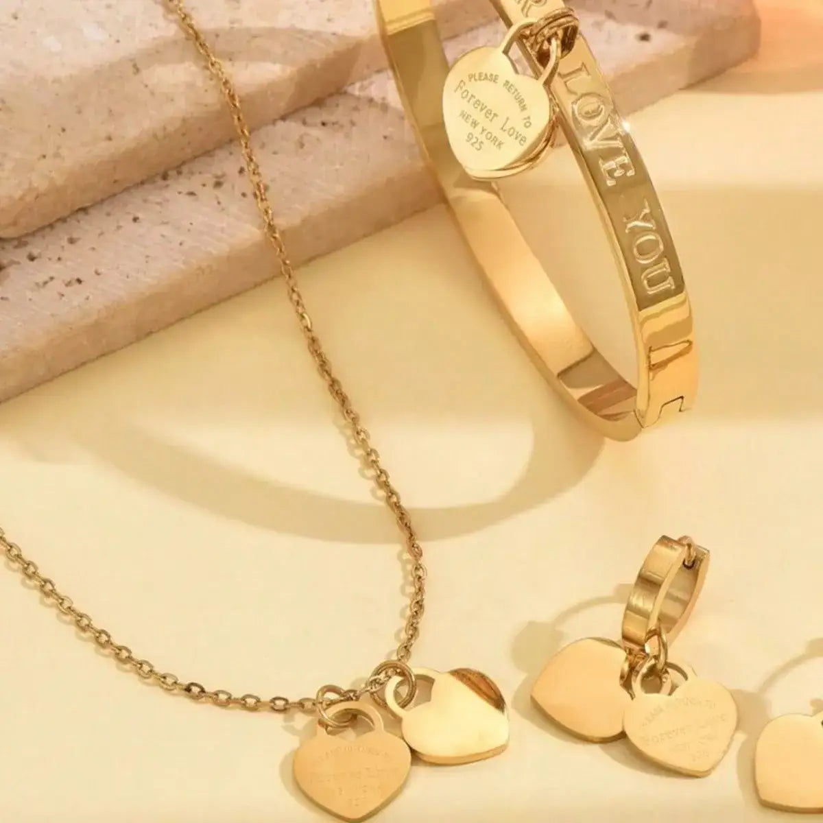 Evie's Dreamland 18K gold-plated heart jewelry set featuring a necklace, bracelet, and earrings.
