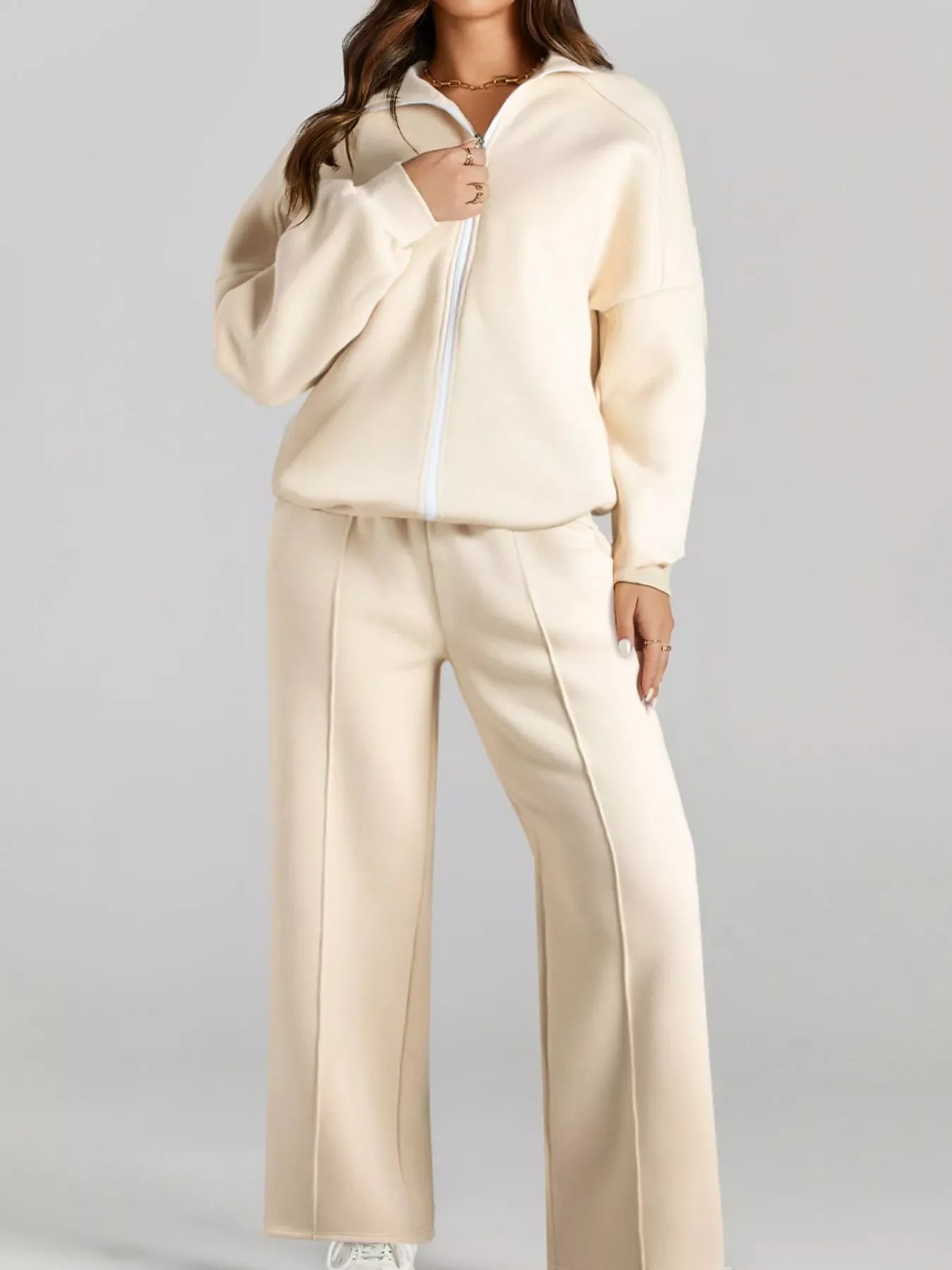 Woman wearing beige zip-up sweatshirt and matching wide-leg pants casual lounge outfit