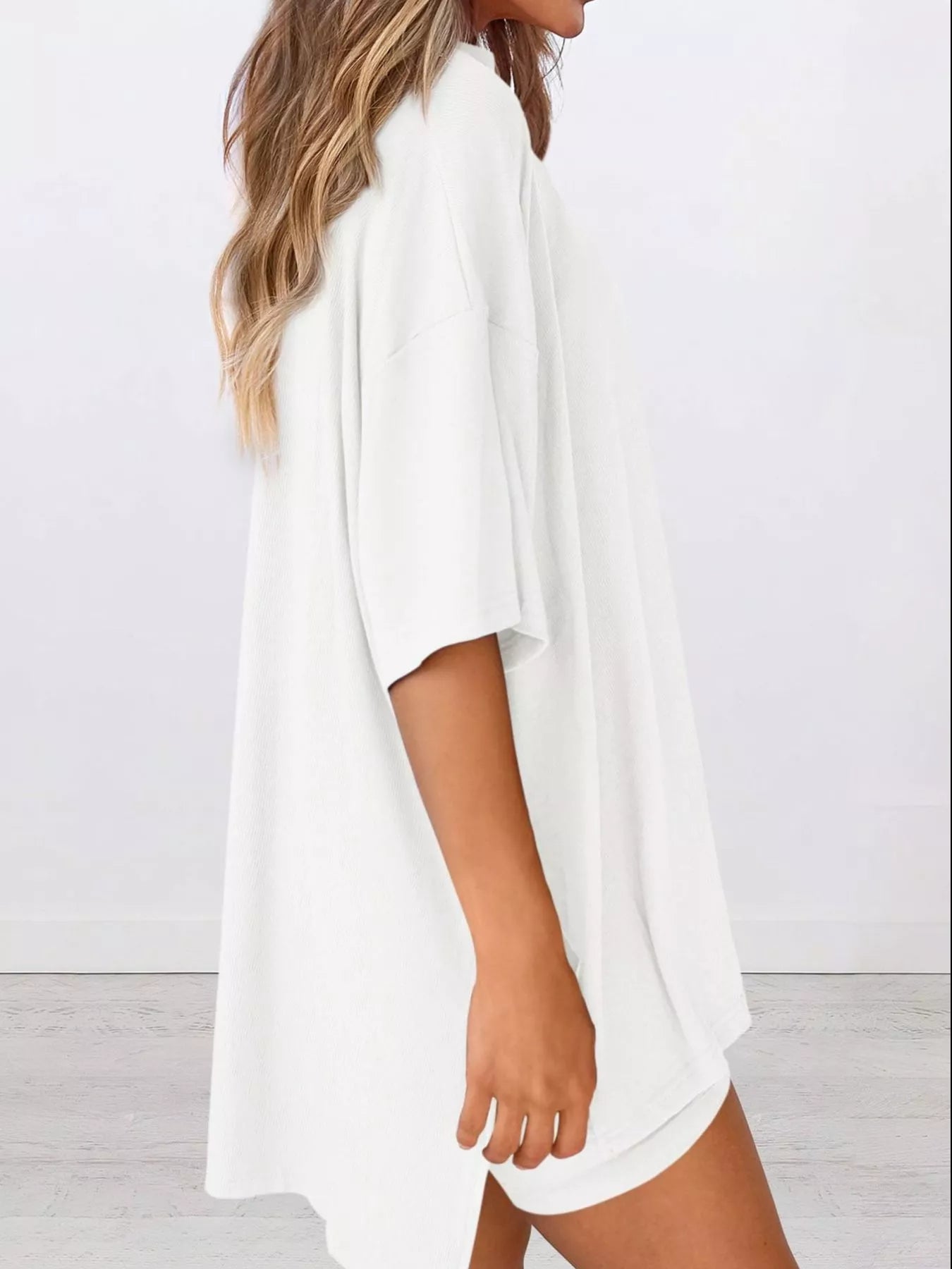 Woman wearing oversized white t-shirt with relaxed fit, casual loungewear style