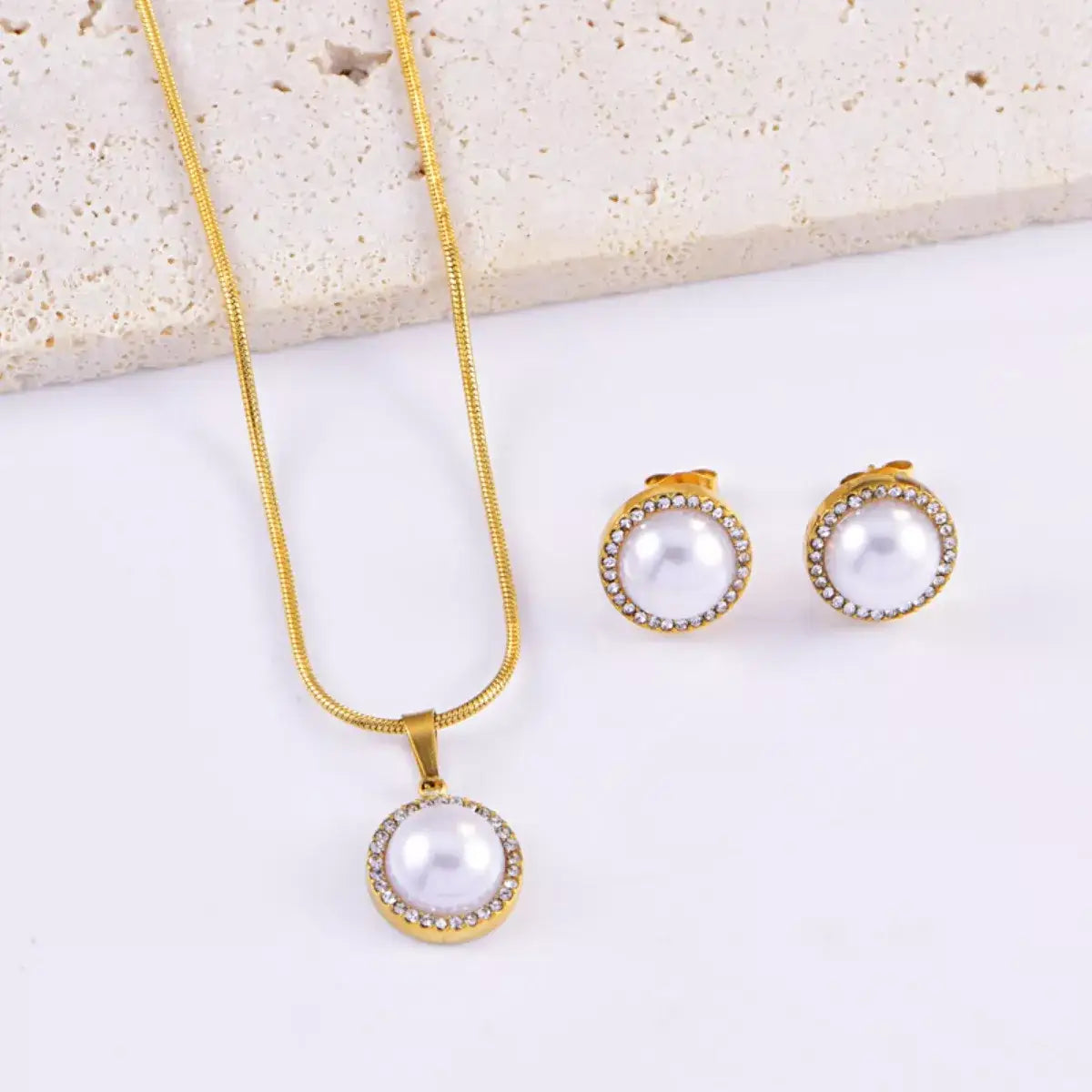 Evie's Dreamland 18K gold-plated pearl necklace and stud earring set with rhinestone halos.