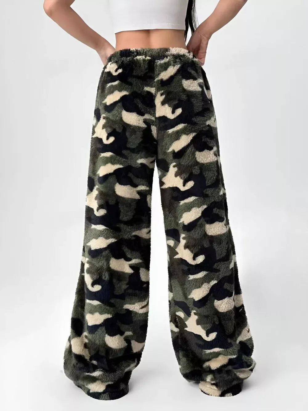 Back view of woman wearing cozy camouflage fleece wide-leg pants with elastic waistband