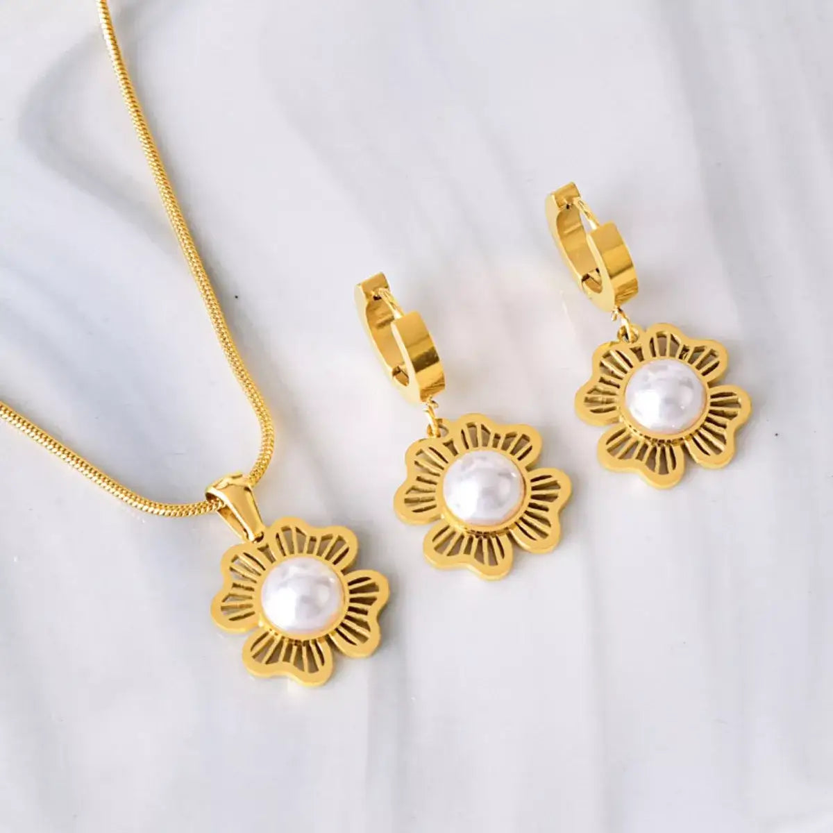 Evie's Dreamland 18K gold-plated flower pearl jewelry set featuring a necklace and matching earrings.