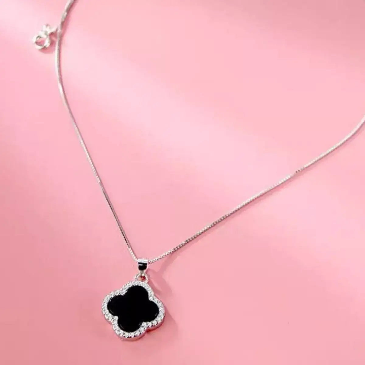 Evie's Dreamland 925 sterling silver necklace featuring a black clover pendant with crystal accents.