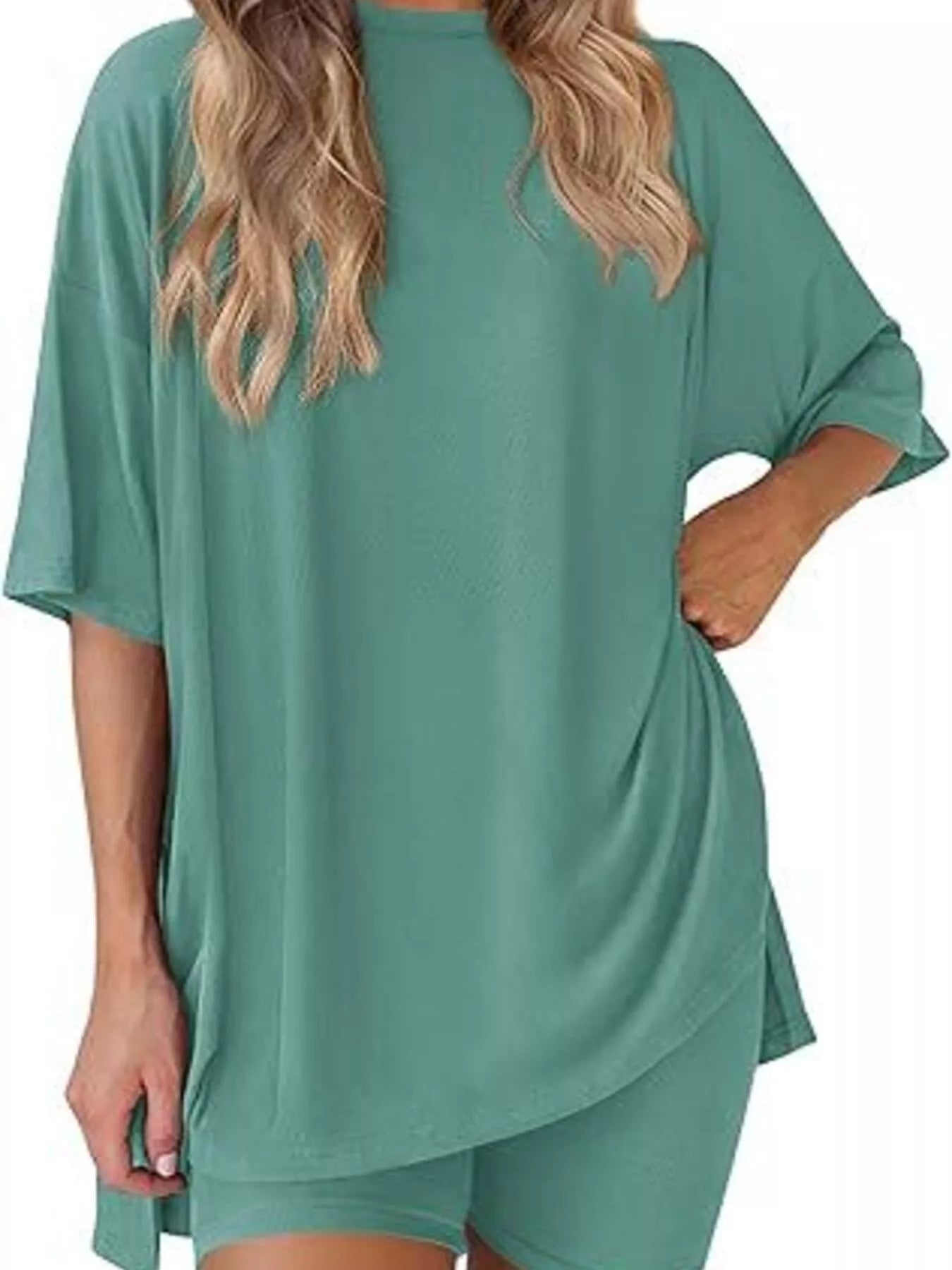 Woman wearing loose teal lounge set with oversized short sleeve top and matching shorts