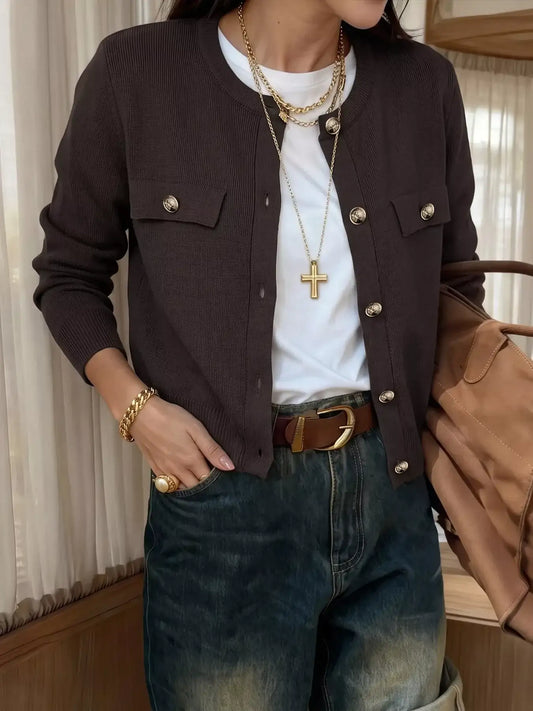 Evie's Dreamland brown button-down knit cardigan with chest pockets, styled with a white tee and blue jeans.