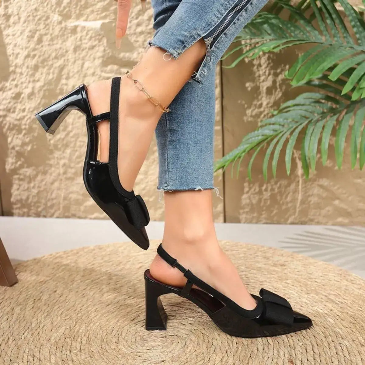 Black pointed toe block heel slingback sandals by Evie's Dreamland with bow detail and mid heel.