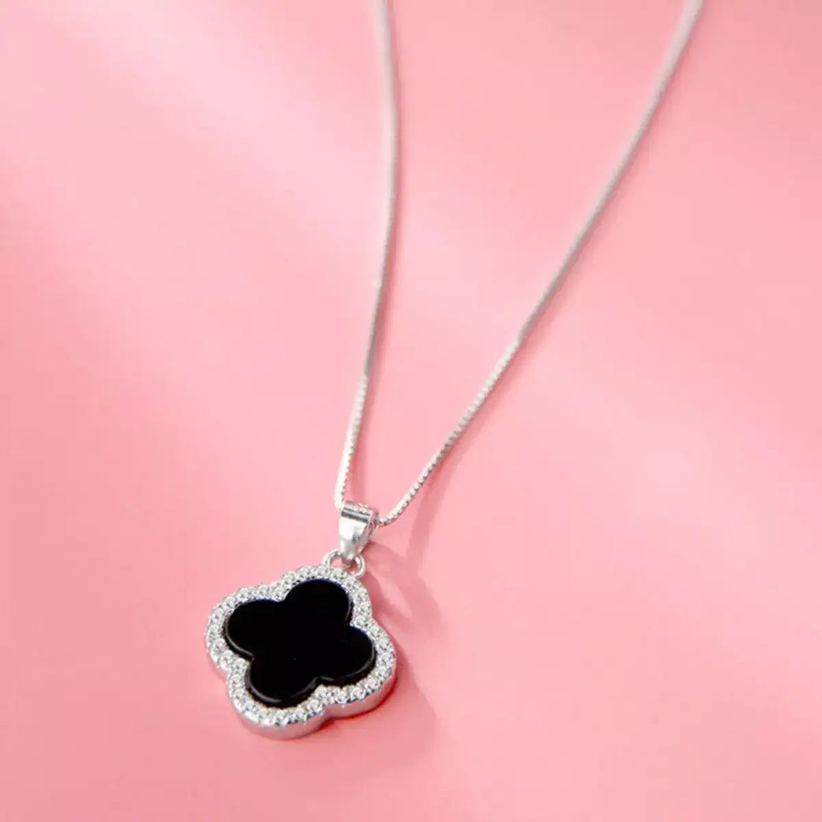 Evie's Dreamland 925 sterling silver clover pendant necklace with a black center and crystal trim.