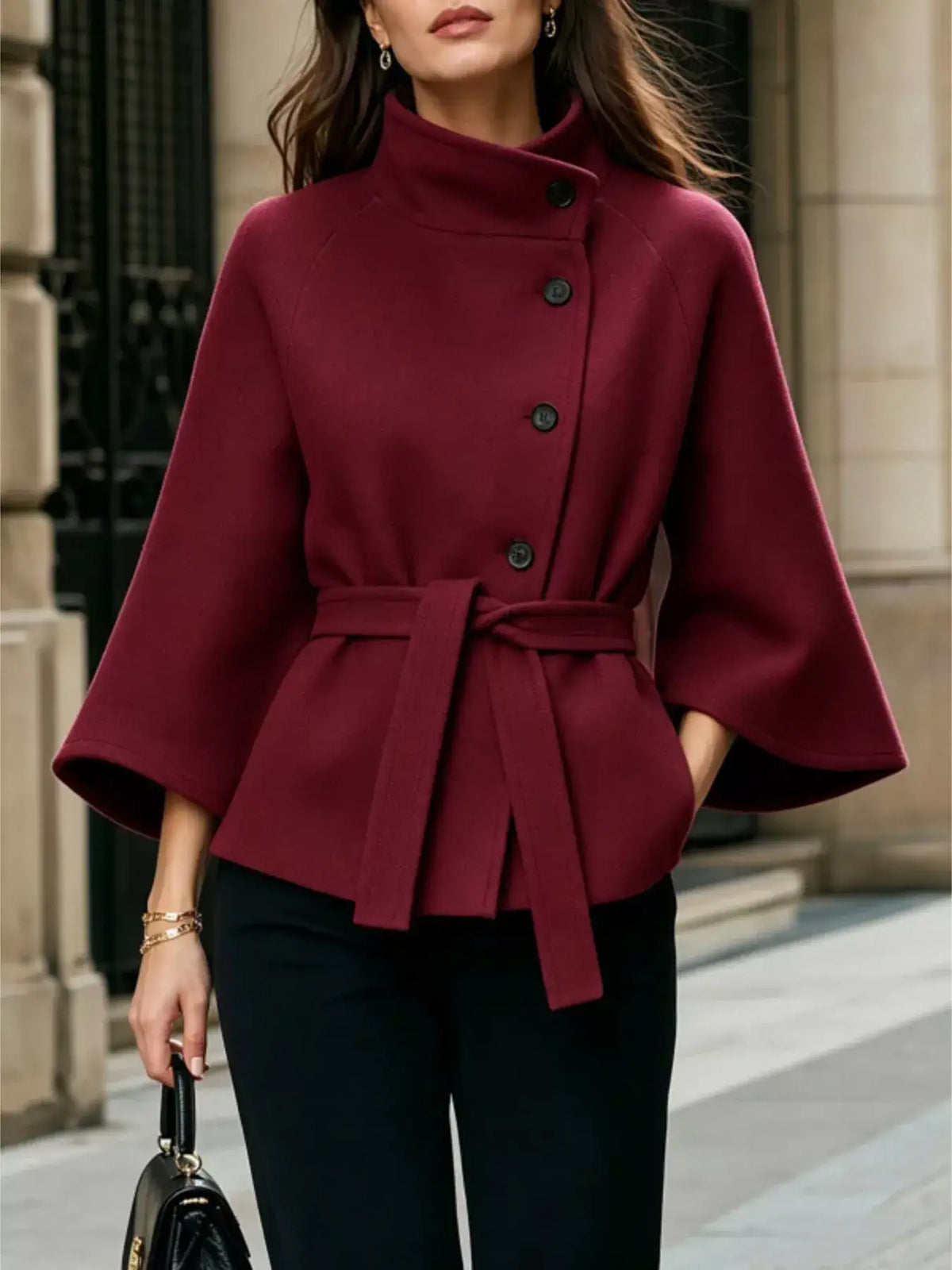 Women's burgundy button-down cape coat by Evie's Dreamland with high collar, belted waist, and wide sleeves.