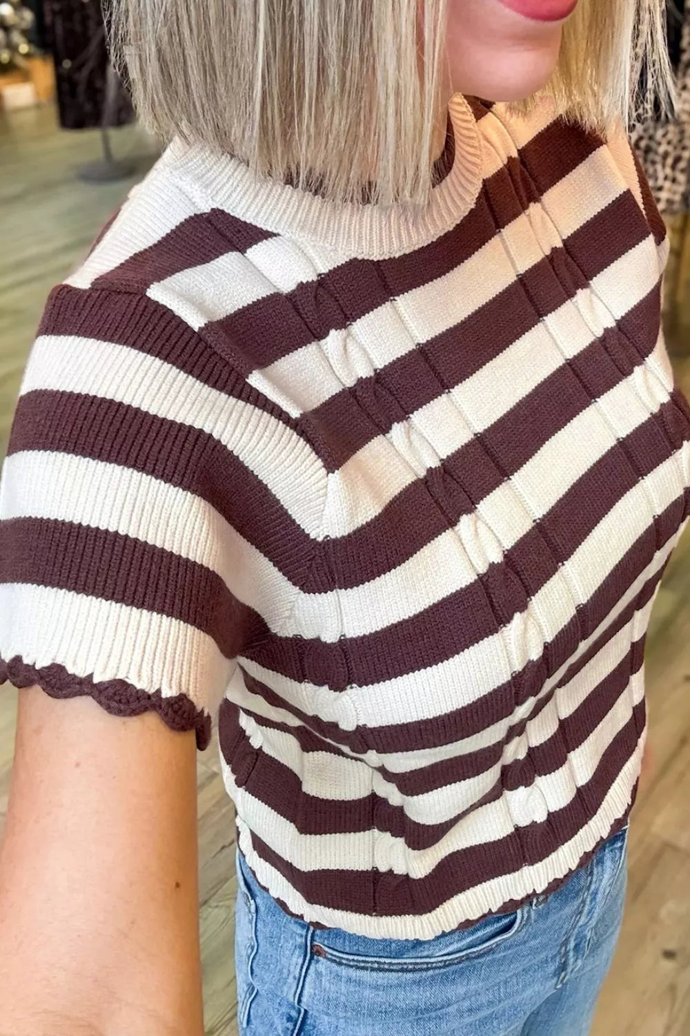 Evie's Dreamland brown and cream striped ribbed cable-knit short sleeve sweater paired with blue jeans.