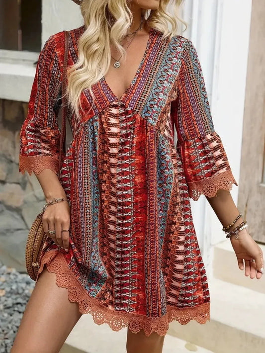 Woman wearing a boho patterned red and orange mini dress with crochet trim