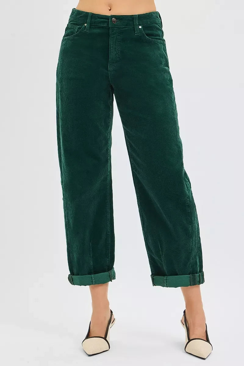 Woman wearing dark green corduroy pants with cuffed hems and beige slingback heels
