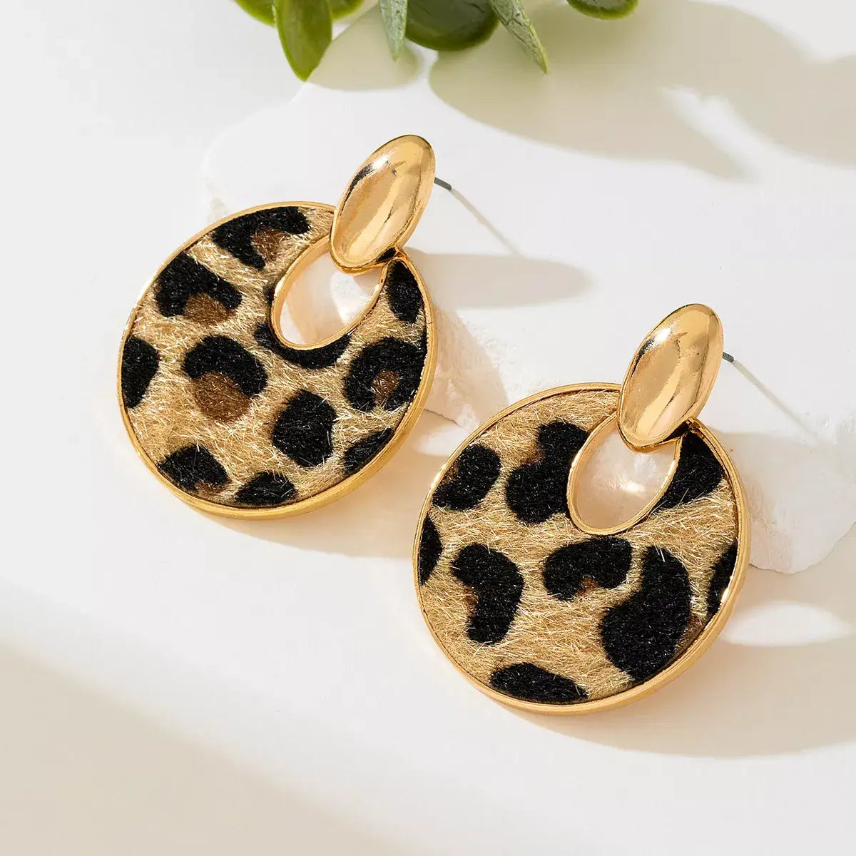 Evie's Dreamland 18K gold-plated circle dangle earrings with a leopard print pattern.