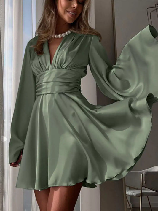 Sage green V-neck satin mini dress by Evie's Dreamland with flowy sleeves and a cinched waist.