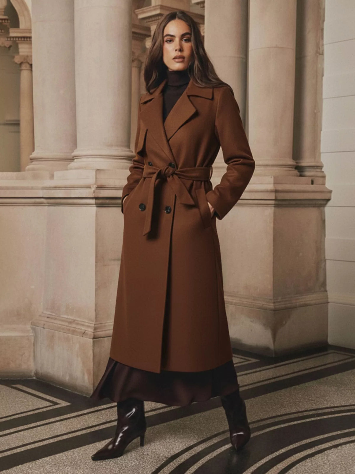 Women's brown lapel collar belted wool blend coat, full length front view, styled with turtleneck and black boots