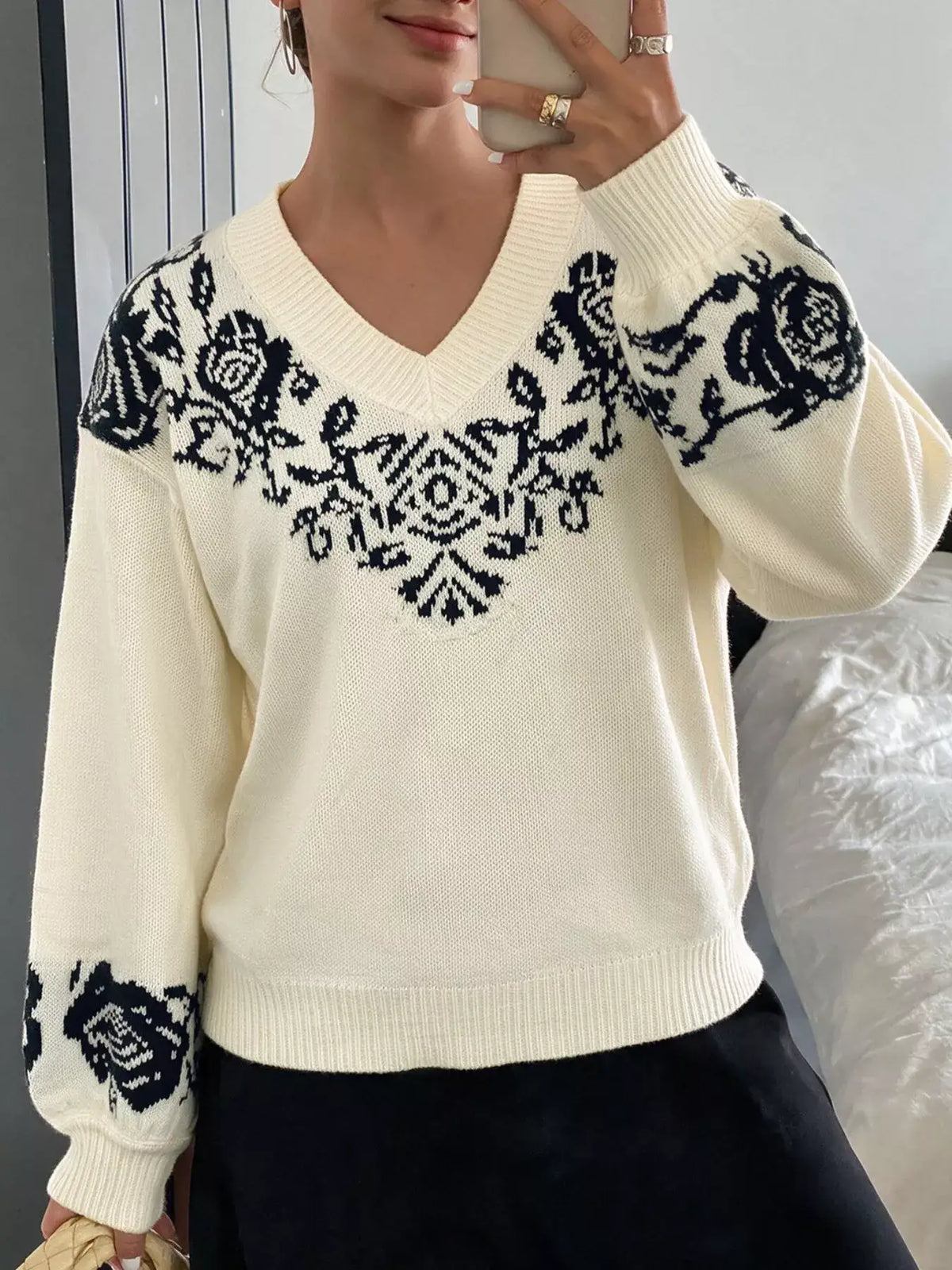 Cream V-neck dropped shoulder sweater by Evie's Dreamland with navy floral patterns on shoulders and sleeves.