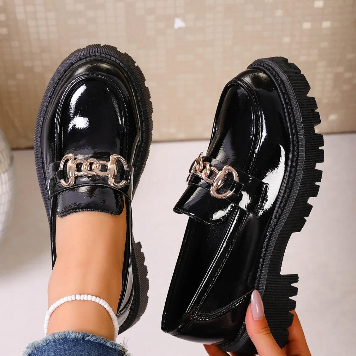 Chunky mid heel detail of women's black faux leather chain loafers