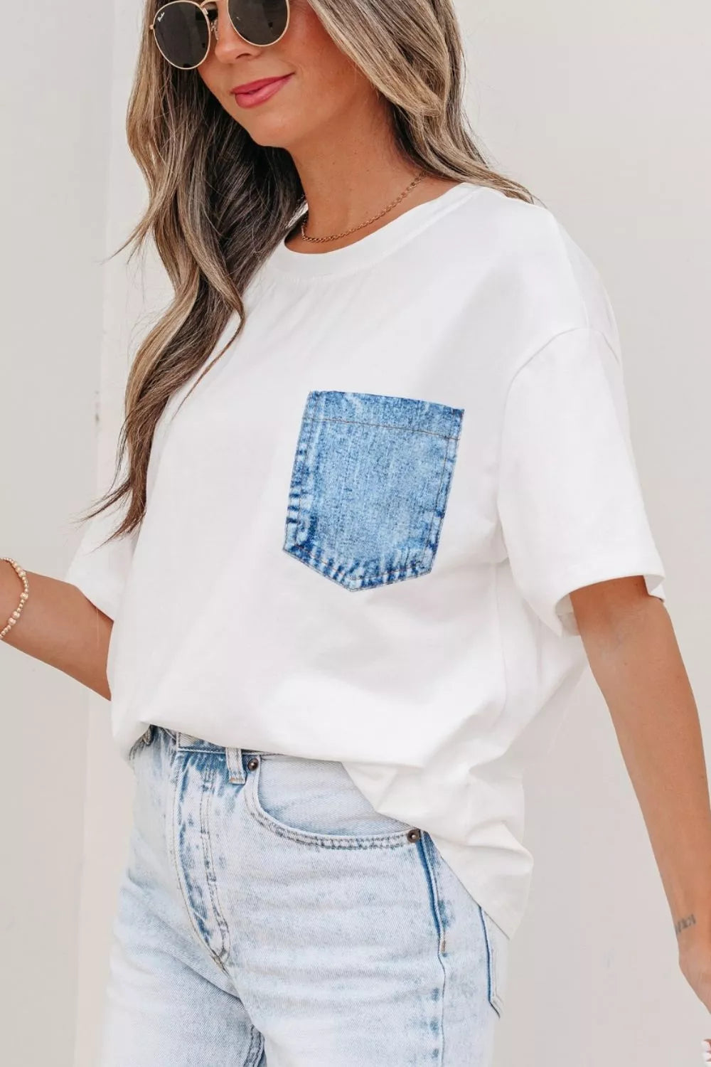White t-shirt with denim pocket paired with light wash jeans, stylish everyday fashion