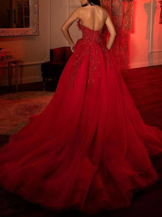 Evie's Dreamland red sequin strapless gown with a high slit and appliqué detail