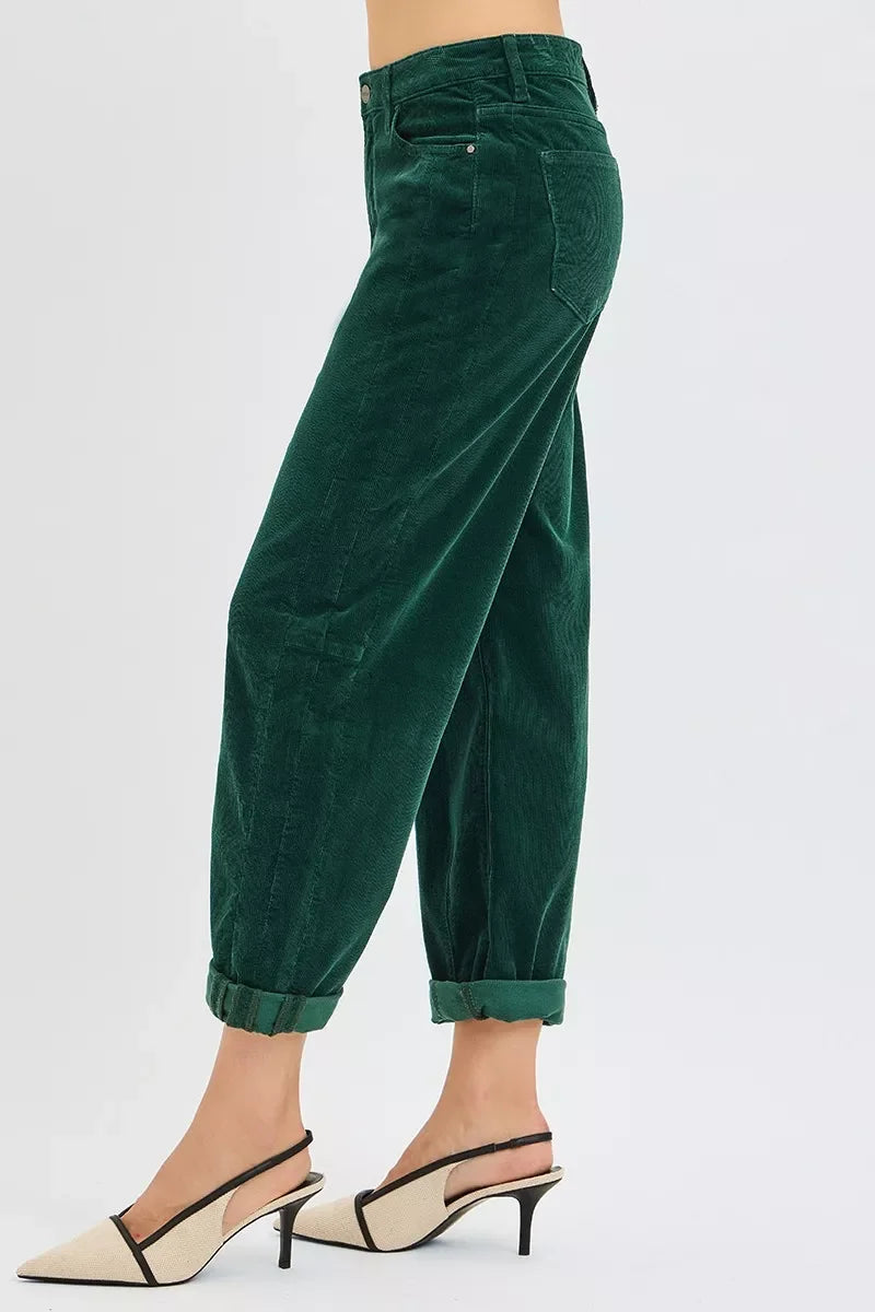 Woman wearing green rolled-up corduroy pants paired with beige slingback kitten heels