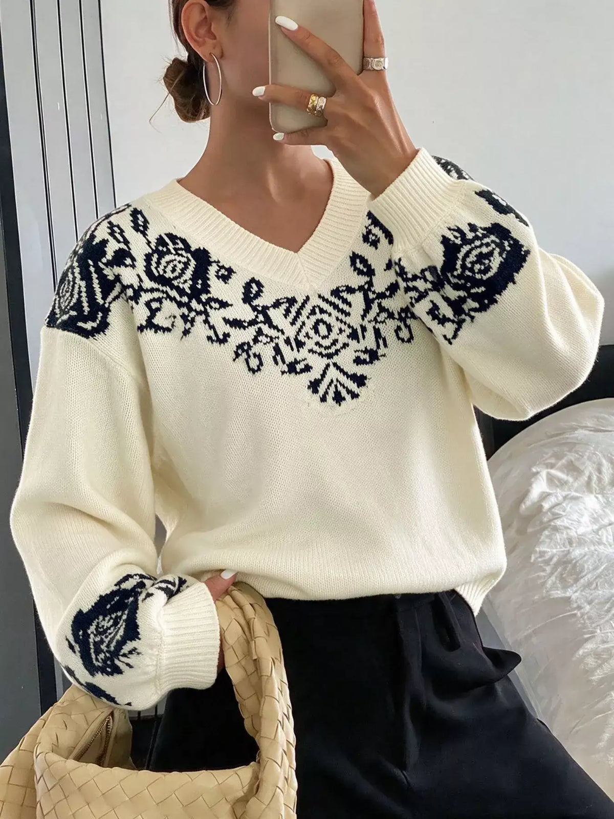 Women's cream Evie's Dreamland V-neck sweater with navy floral patterns and dropped shoulders.