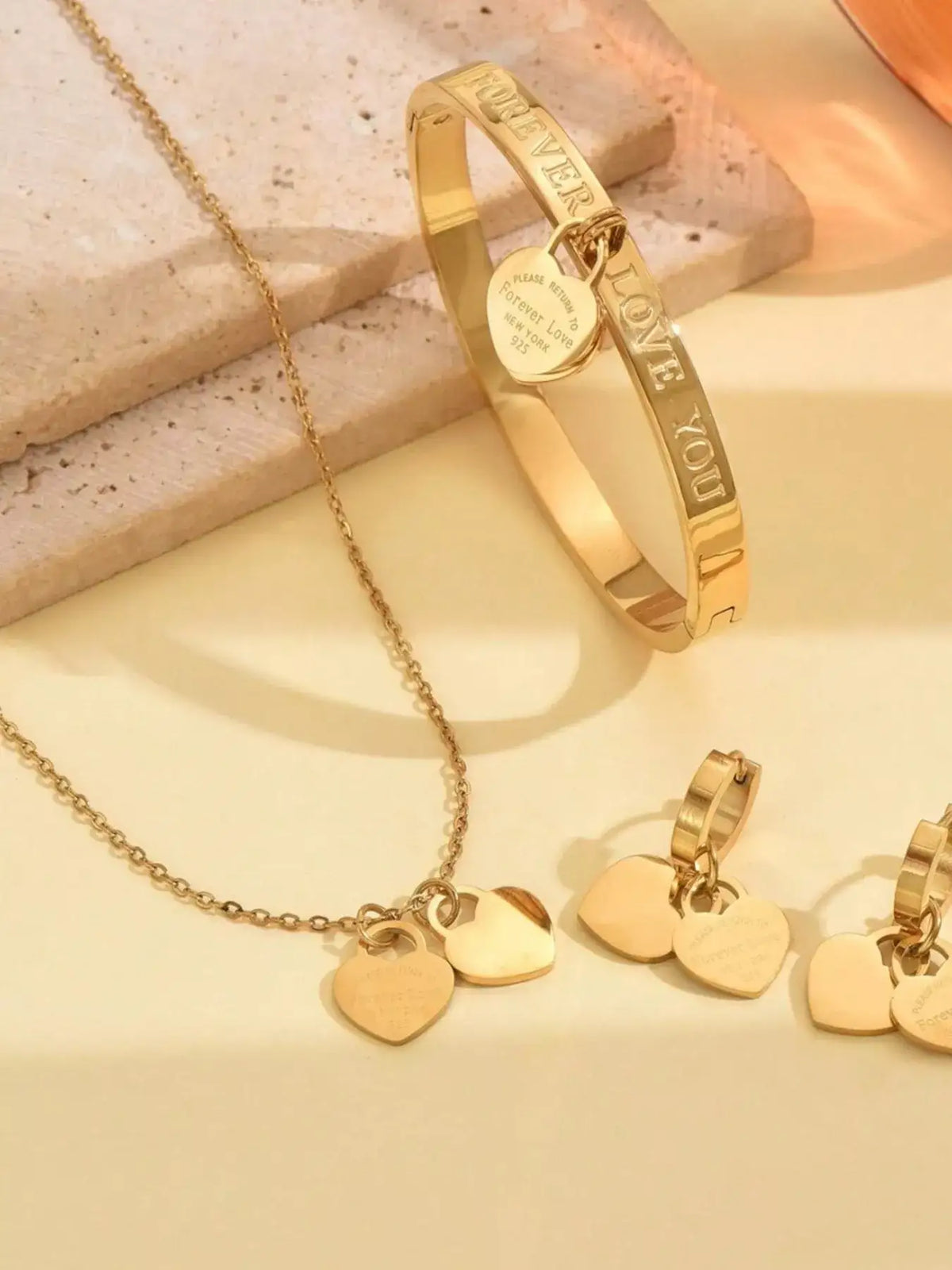 Evie's Dreamland 18K gold-plated heart jewelry set including a necklace, bangle, and earrings.