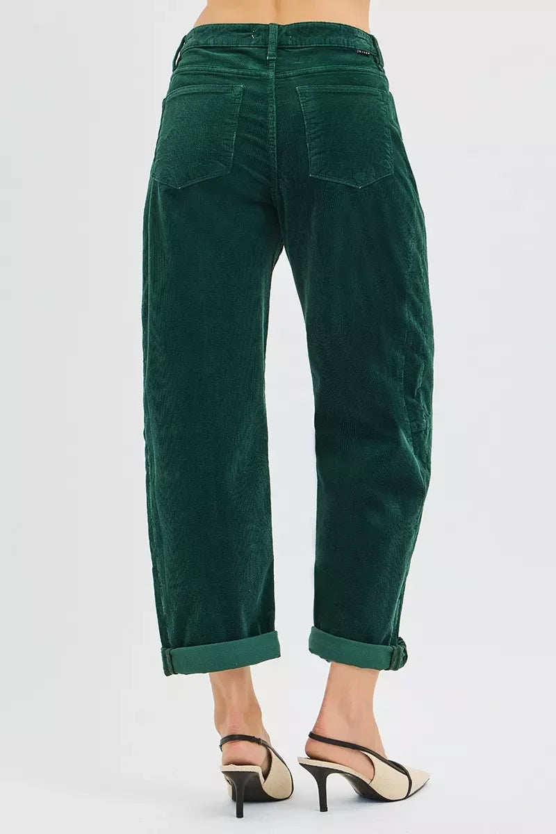 Back view of woman wearing dark green corduroy cuffed pants and beige heeled slingback shoes