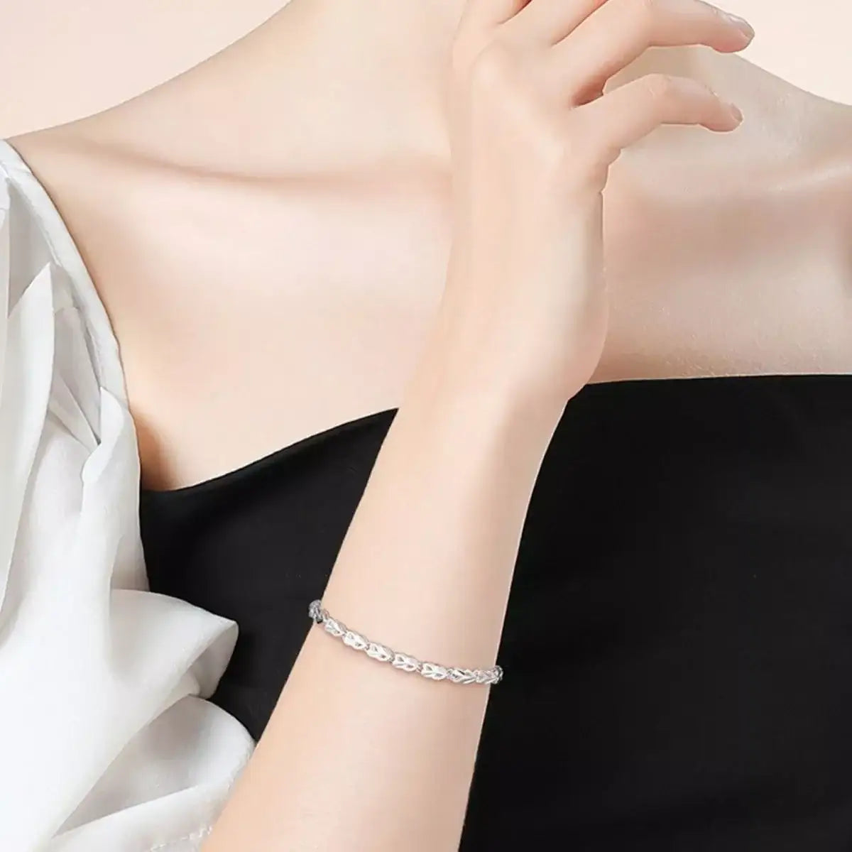 Trendsi 925 sterling silver heart link bracelet worn on a woman's wrist.