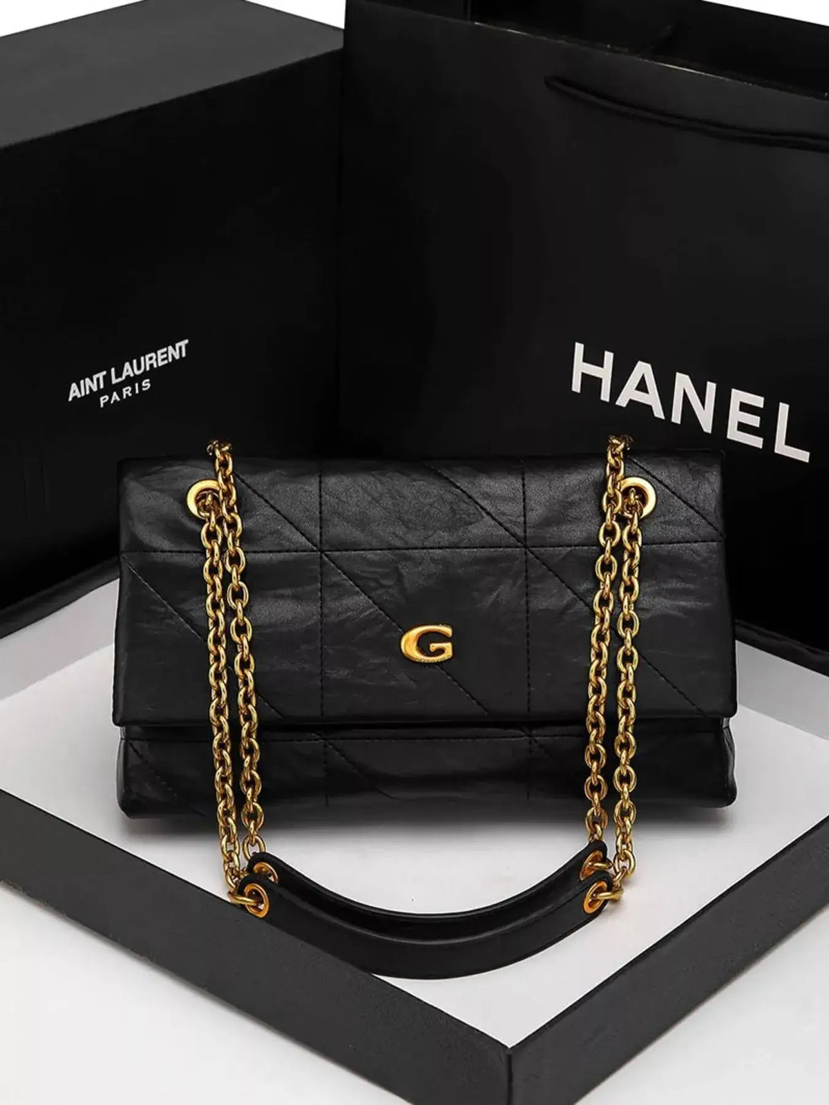 Evie's Dreamland black geometric quilted shoulder bag with a gold chain strap and G-shaped clasp.