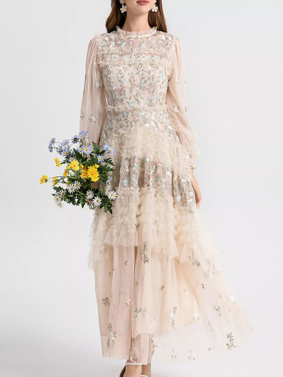 Woman wearing an apricot floral embroidered tulle maxi dress from Evie's Dreamland