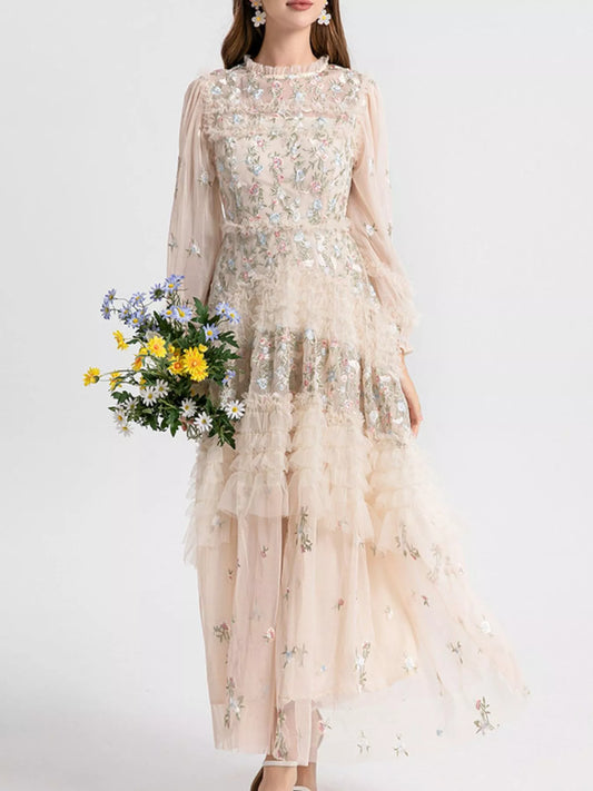 Woman wearing an apricot floral embroidered tulle maxi dress from Evie's Dreamland