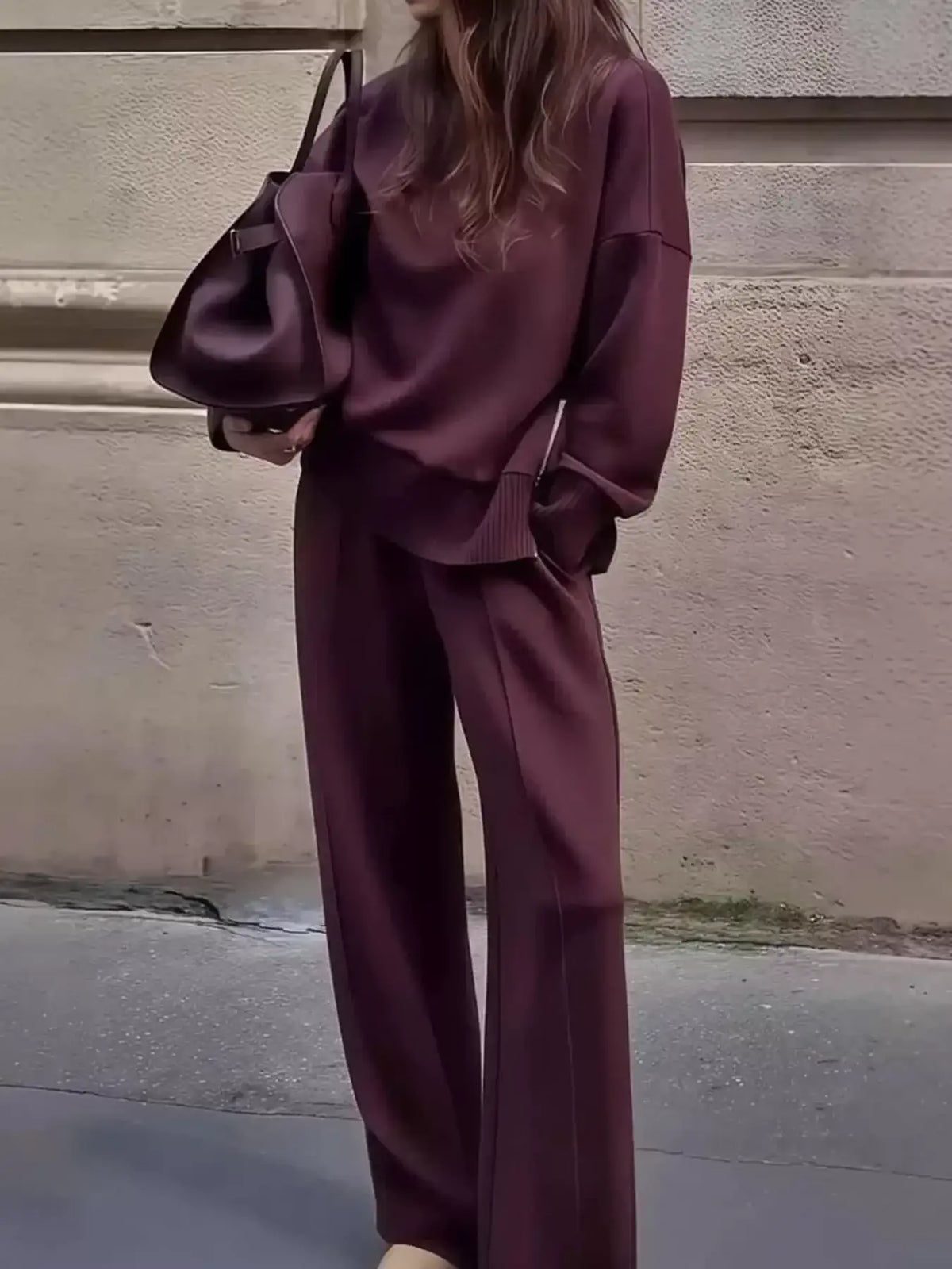 Evie's Dreamland burgundy ribbed sweatshirt and wide-leg pants set paired with a matching handbag.