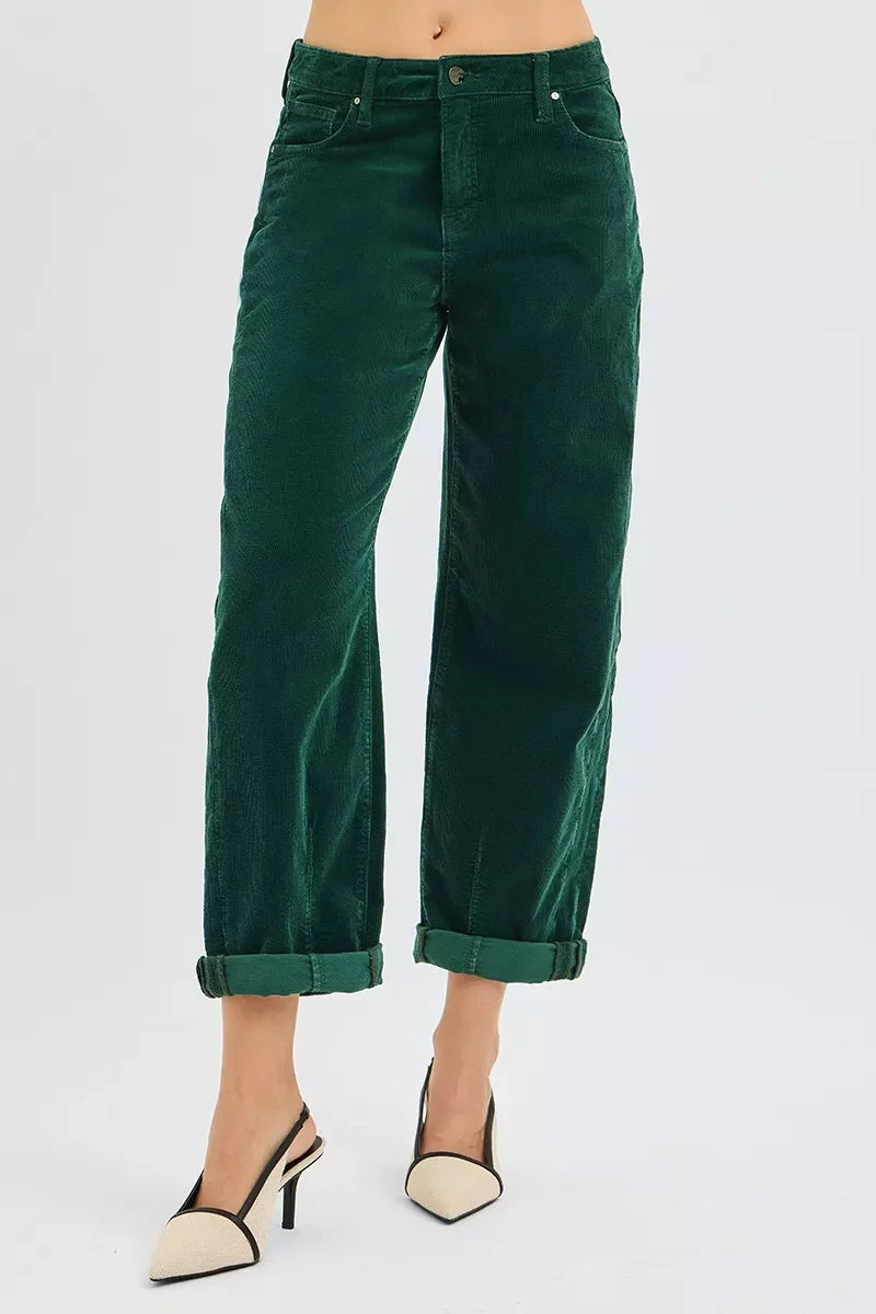 Woman wearing rolled-up dark green corduroy pants and beige pointed-toe high heels