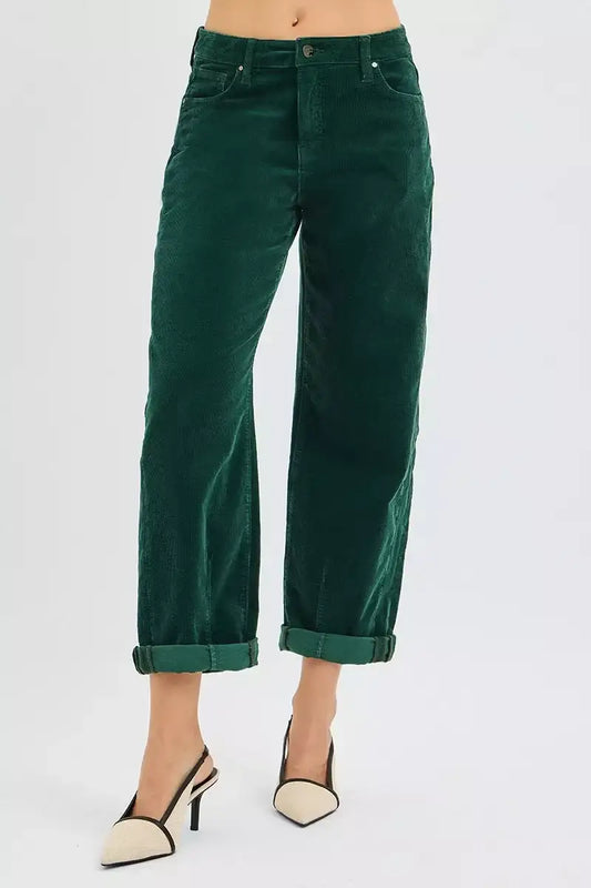 Woman wearing rolled-up dark green corduroy pants and beige pointed-toe high heels