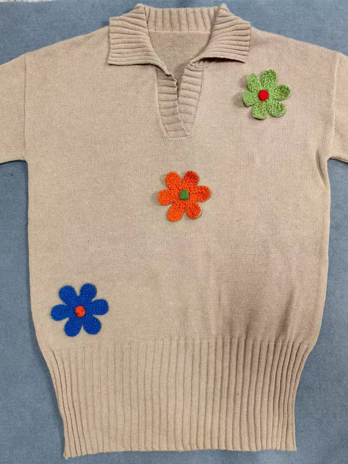 Beige Evie's Dreamland ribbed sweater dress with colorful floral appliques and a polo collar.