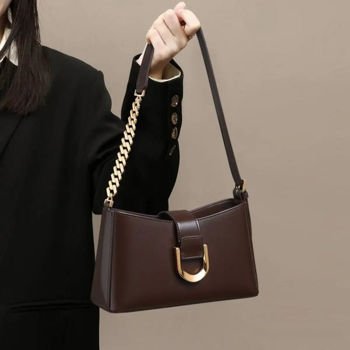 Evie's Dreamland dark brown PU leather shoulder bag with a gold chain strap and buckle detail.