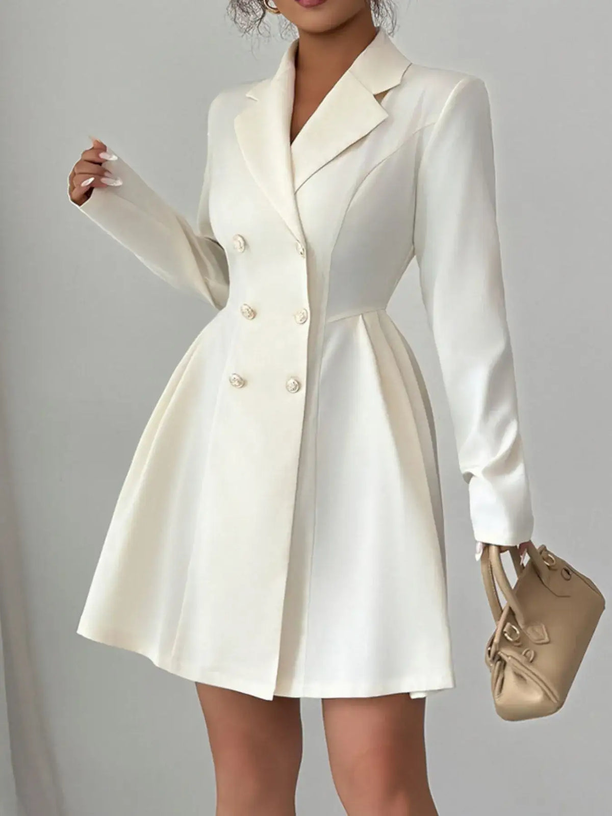Evie's Dreamland white double-breasted blazer dress with long sleeves and a pleated skirt.