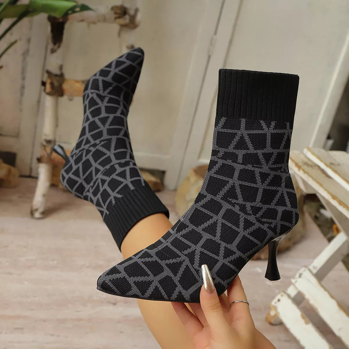 Women's black and grey geometric pattern knit sock boots with stiletto heels