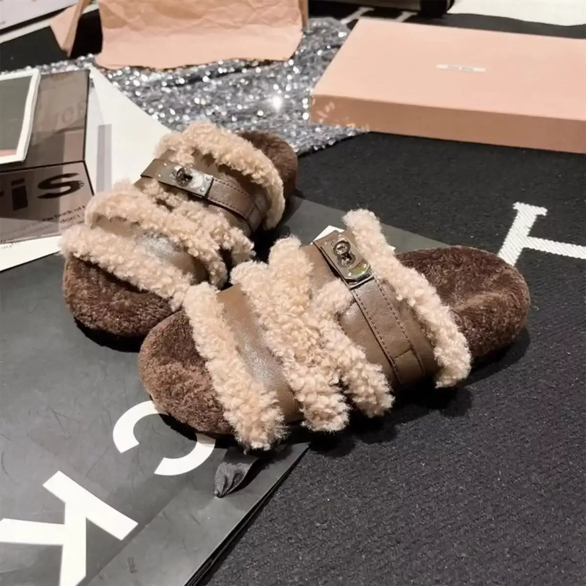 Brown Evie's Dreamland fuzzy buckle slippers with plush faux fur trim and metal buckle detail.