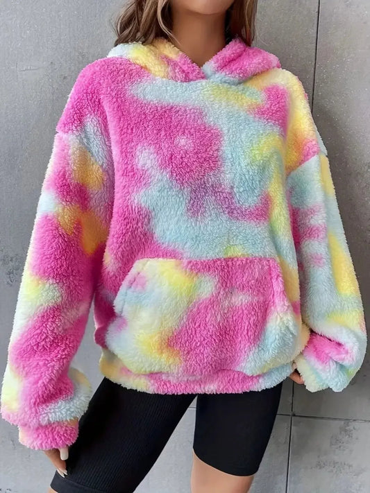 Woman wearing colorful fluffy tie-dye hoodie with pink, yellow, and blue shades and front pocket