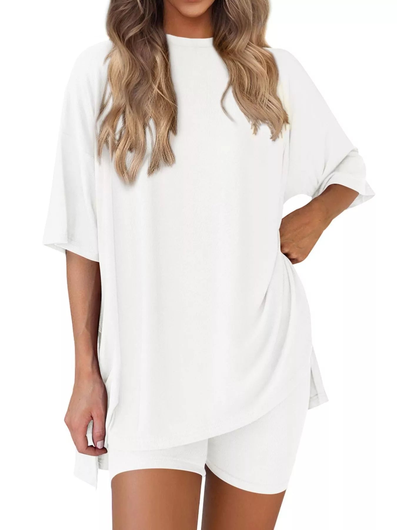Woman wearing a cozy white loungewear set with oversized t-shirt and shorts