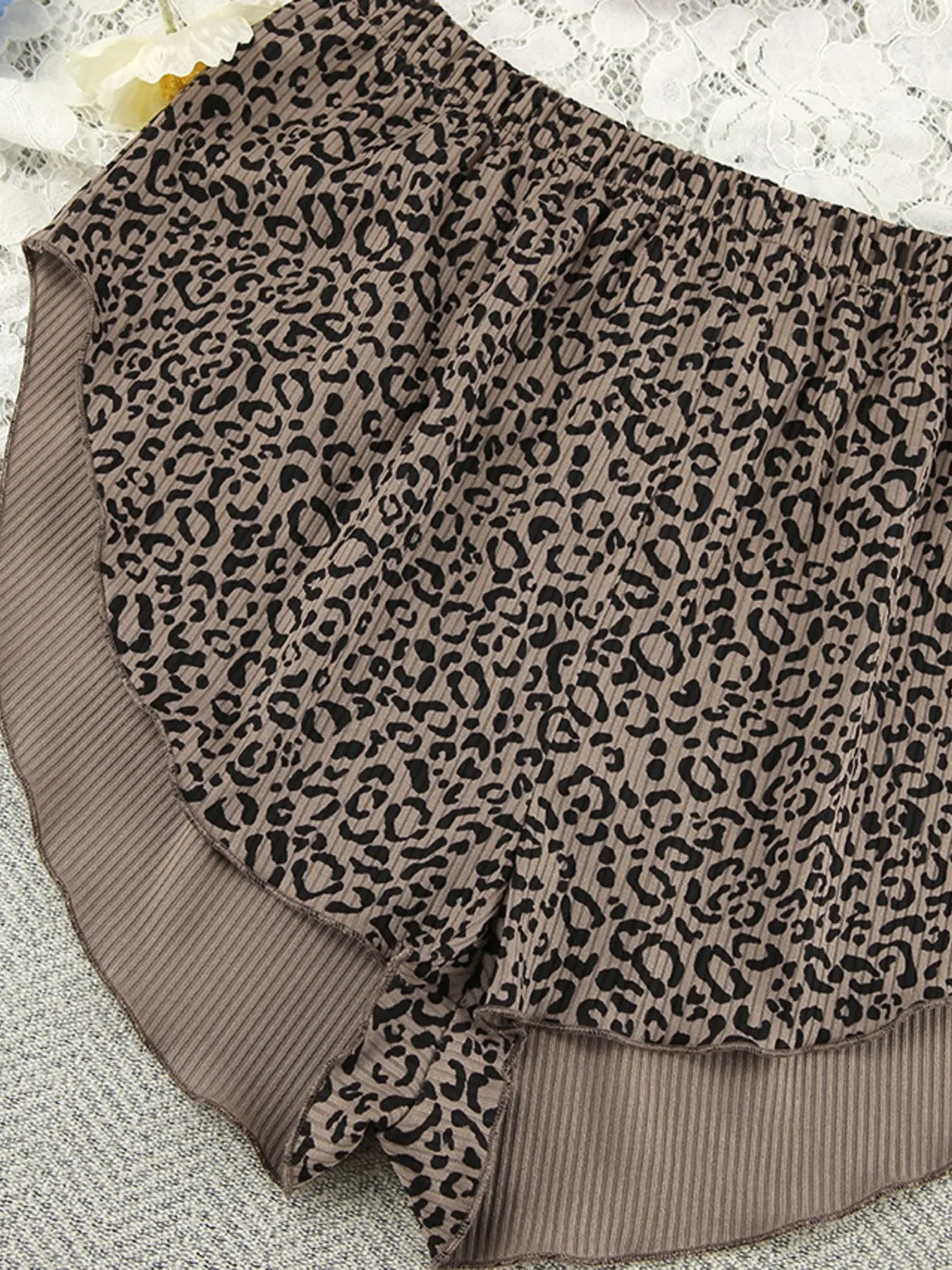 Brown leopard print women's shorts with ribbed fabric and elastic waistband on lace background