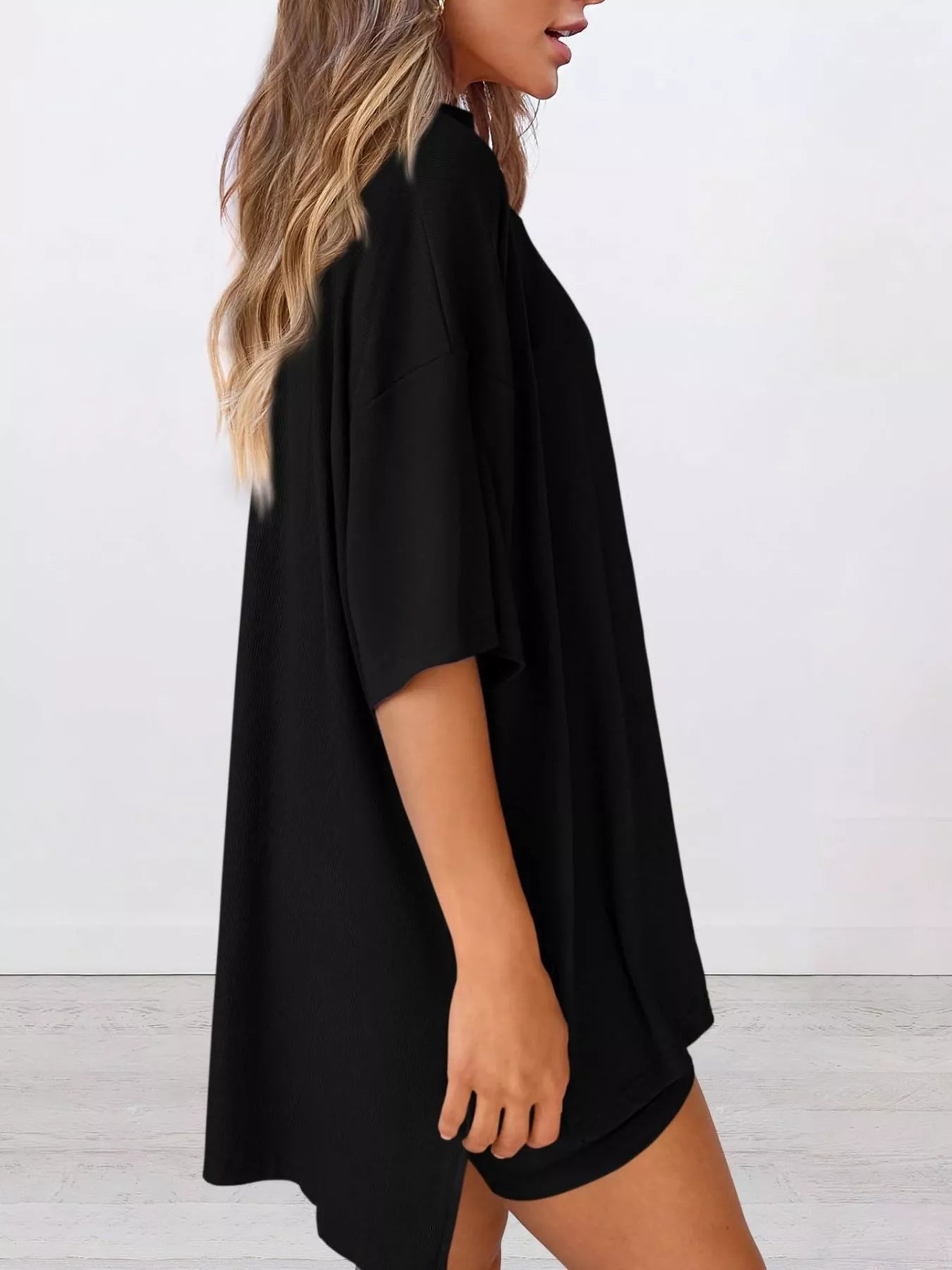 Woman wearing loose black oversized t-shirt with short sleeves, casual style outfit