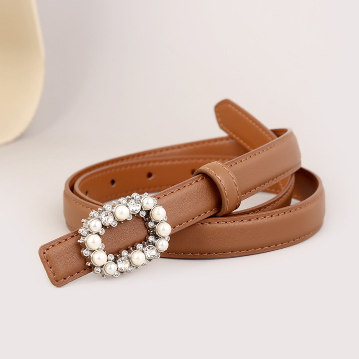Tan faux leather women's belt with an oval pearl and rhinestone buckle