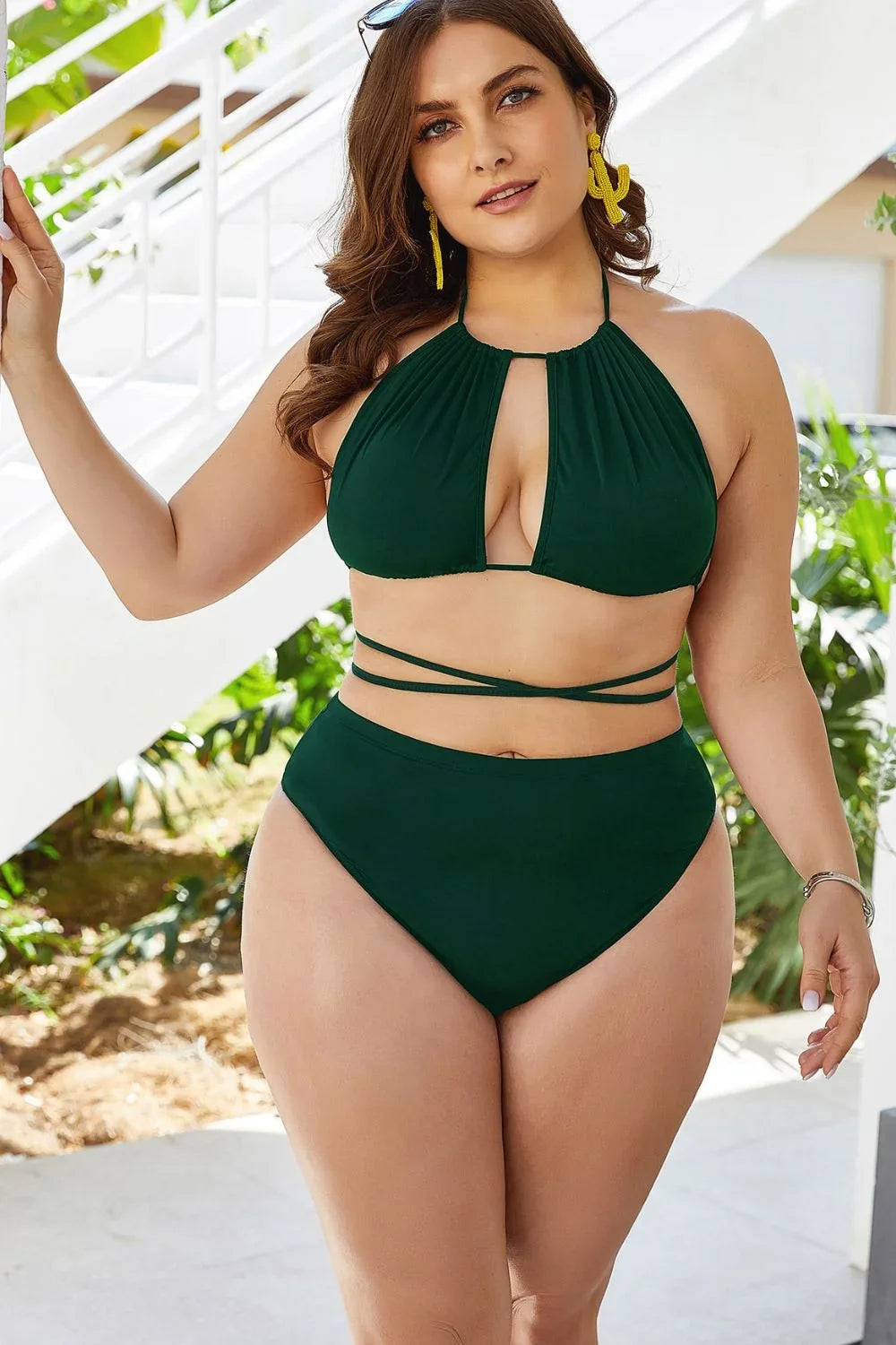 Plus size backless halter bikini set styled for a summer beach day.
